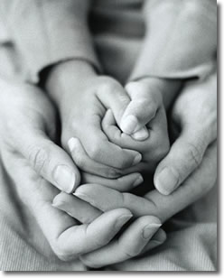 Child's hands within parent's hands