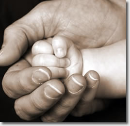 Baby's hand in adult's hand